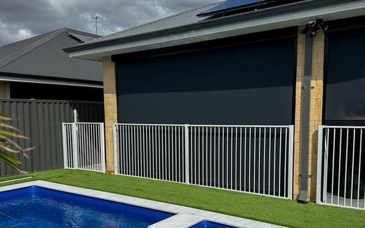 White aluminium tubular pool fence around a pool at a modern home