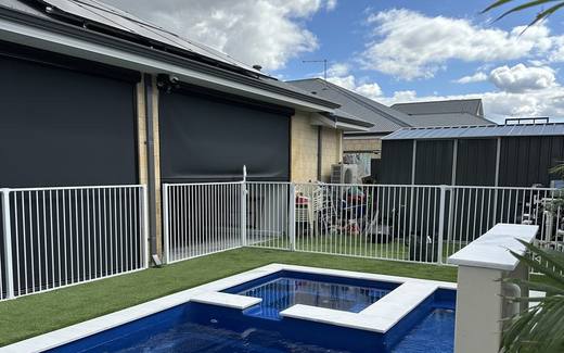 White aluminium tubular pool fence around a pool at a newly built home