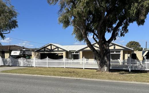 White PVC picket fence running the full street frontage of a Perth home