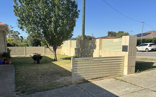 Cream aluminium slat screening set between rendered pillars at a front boundary