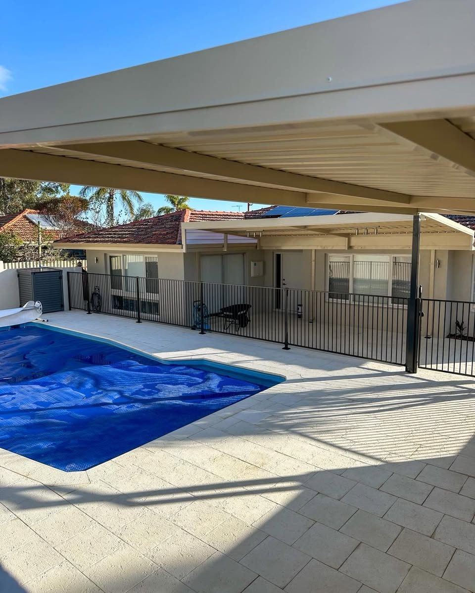 Tubular pool fencing beside a covered patio and pool
