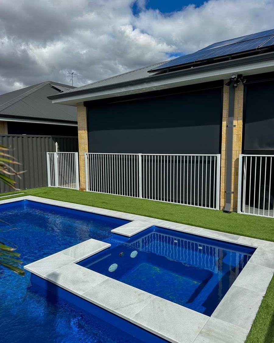 White aluminium tubular pool fence around a pool at a modern home
