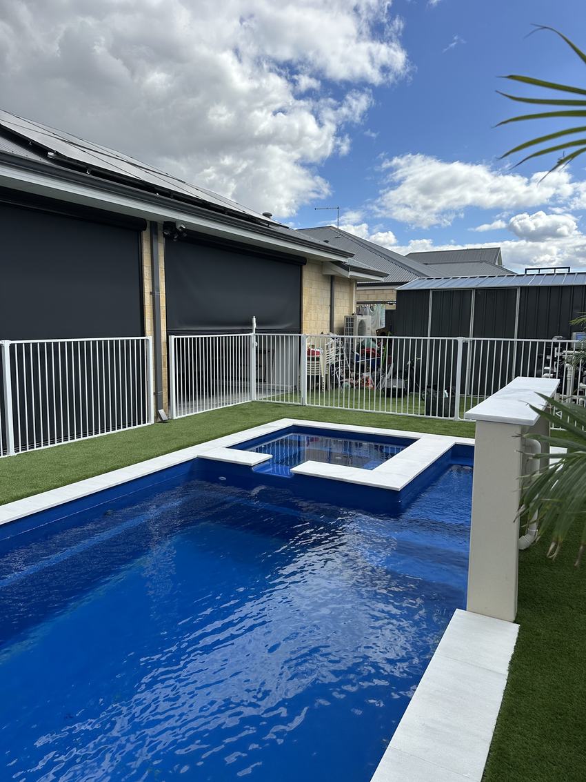 White aluminium tubular pool fence around a pool at a newly built home