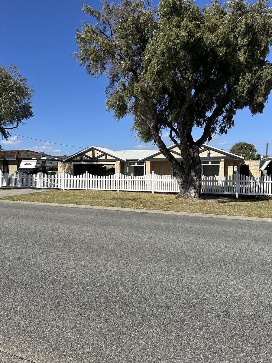 Completed white PVC picket fence across the frontage of a Perth home